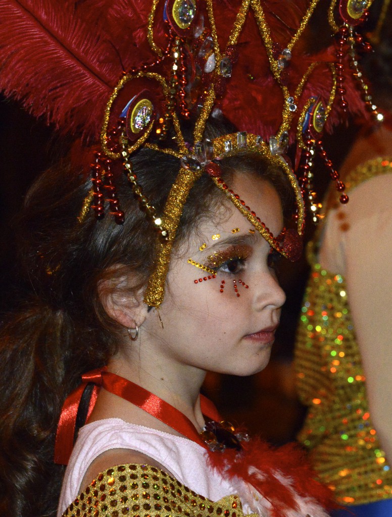 Girl with red eyelashes in the carnival celebrations of the Canary Islands, travel adventures of the best kind. (Image © Meredith Mullins.)
