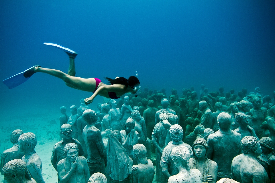 A woman snorkeling in the underwater museum of Jason deCaires Taylor that shows innovations of artist and ocean. (image © Jason deClaire Taylor).