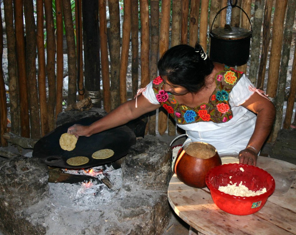 A Mexican woman making corn tortillas by hand, showing an ongoing connection to Mexico's cultural heritage and traditions (Image © Frank Kolvachek)
