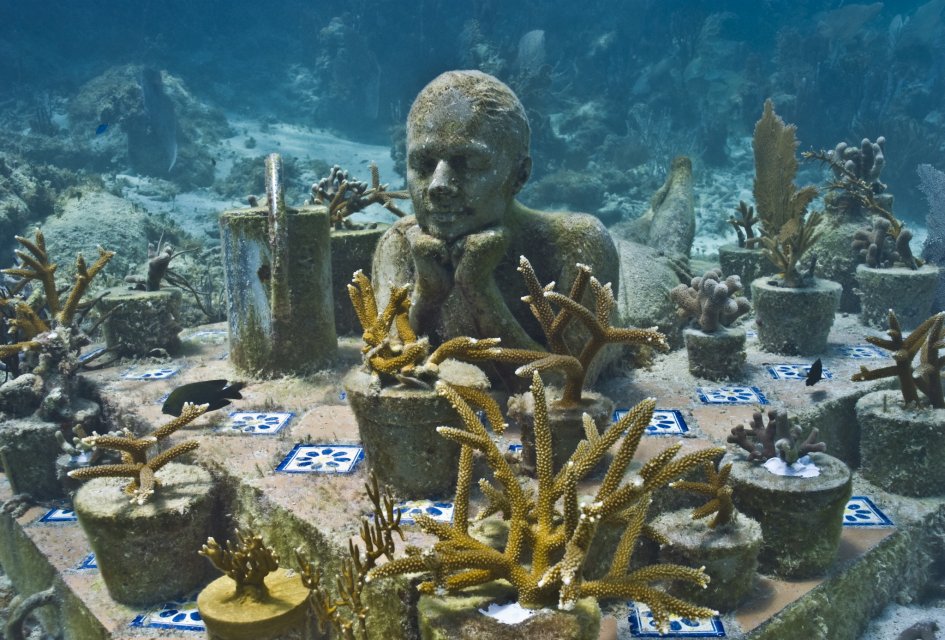 A sculpture of a girl in a garden of coral in Jason deCaires Taylor's underwater museum, showing innovations by both artist and ocean. (Image © Jason deCaires Taylor)