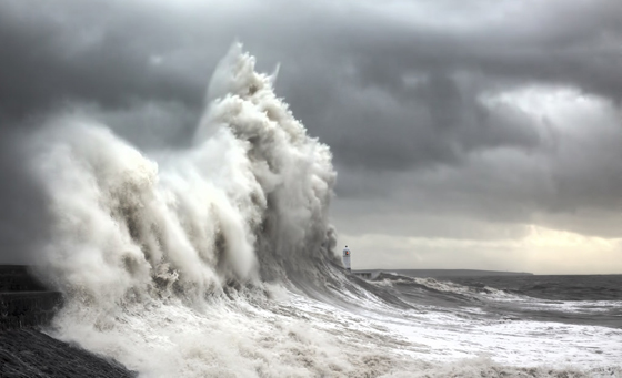 Waves threatening Porthcawl lighthouse, one of the most amazing places on earth to photography. (Image © Steven Garrington.)