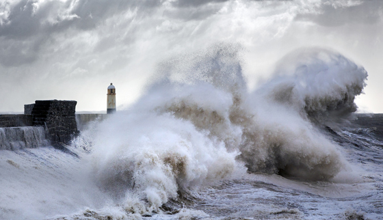 Waves to the right of Porthcawl lighthouse in Wales, one of the most amazing places on earth to photograph. (Image © Steven Garrington.)