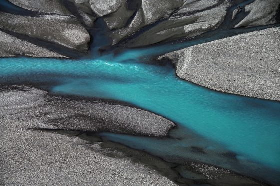 Stones and turquoise water in Argentina, landscape photography creating a virtual journey and a celebration of Earth Day. (Image © Dare Turnšek.) 