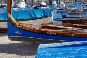 The brightly painted wooden boats, or luzzus, in Gozo, Malta inspired the wanderlust of wordplay poet and watercolor painter Edward Lear. (Image by Joyce McGreevy)