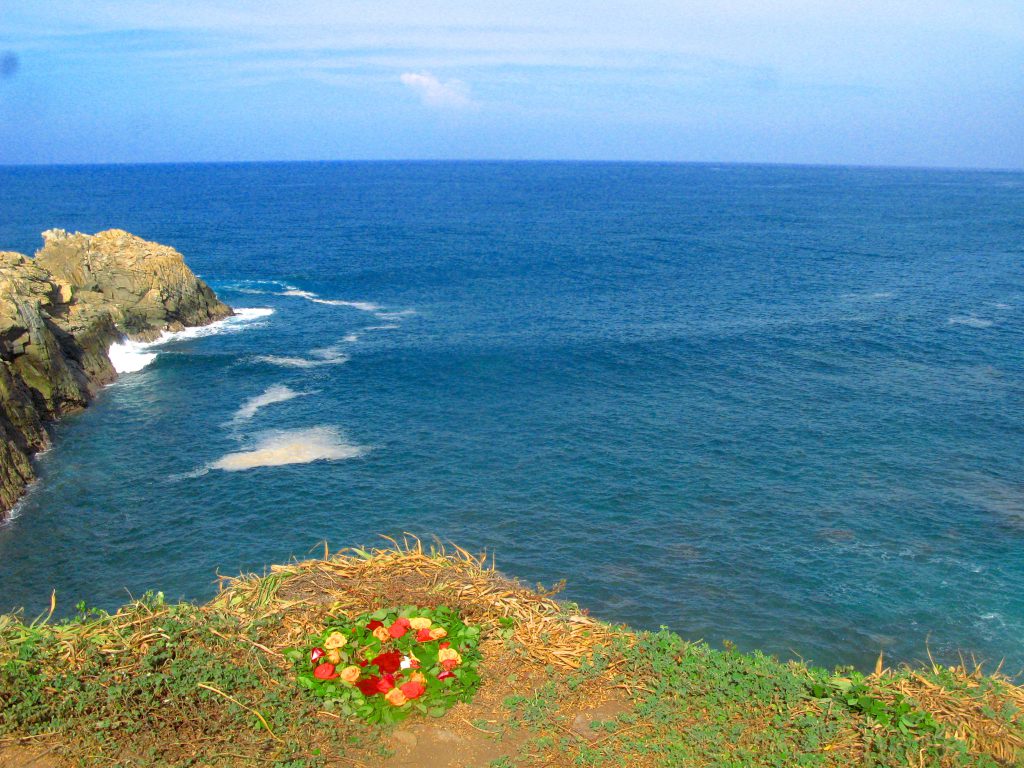 A view from a cliff to a fishing spot by the ocean in Mazunte, Mexico, showing the site of fishing lessons that provided an authentic cultural experience for the writer. (image © Eva Boynton).
