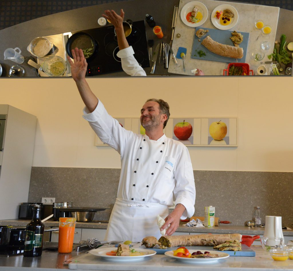 Chef Hubert Hohler demonstrates organic cooking to use before and after fasting to challenge the cultural traditions of food. (Image © Meredith Mullins.)