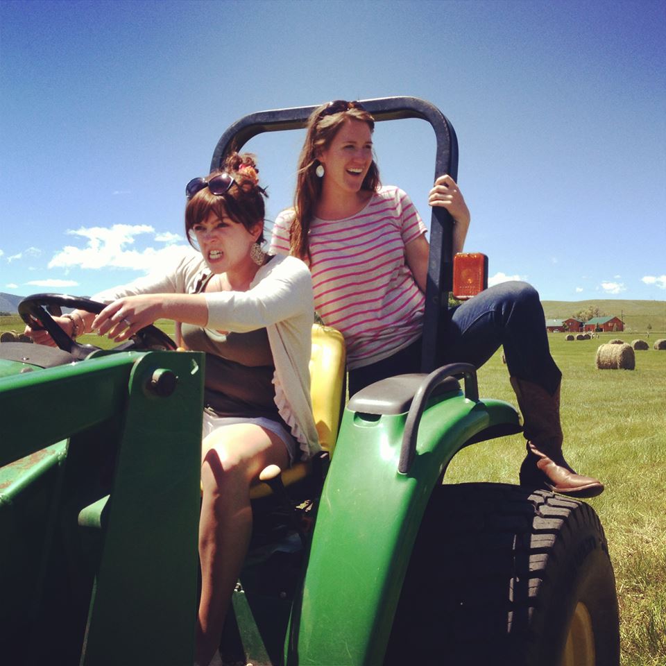 Two women on a tractor at a WWOOF farm where they learn new skills and may develop into a global citizen. (image © Lizzy Eichorn).