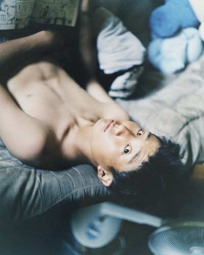 Young man on bed by Shizuka Sato, showing Japanese traditions, reverence for nature, and passing of time. (Image © Shizuoka Sato.)