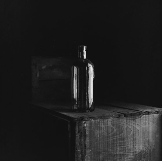 Bottle on table, a photograph by Satoru Watanabe showing Japanese traditions and reverence for nature. (Image © Satoru Watanabe.)