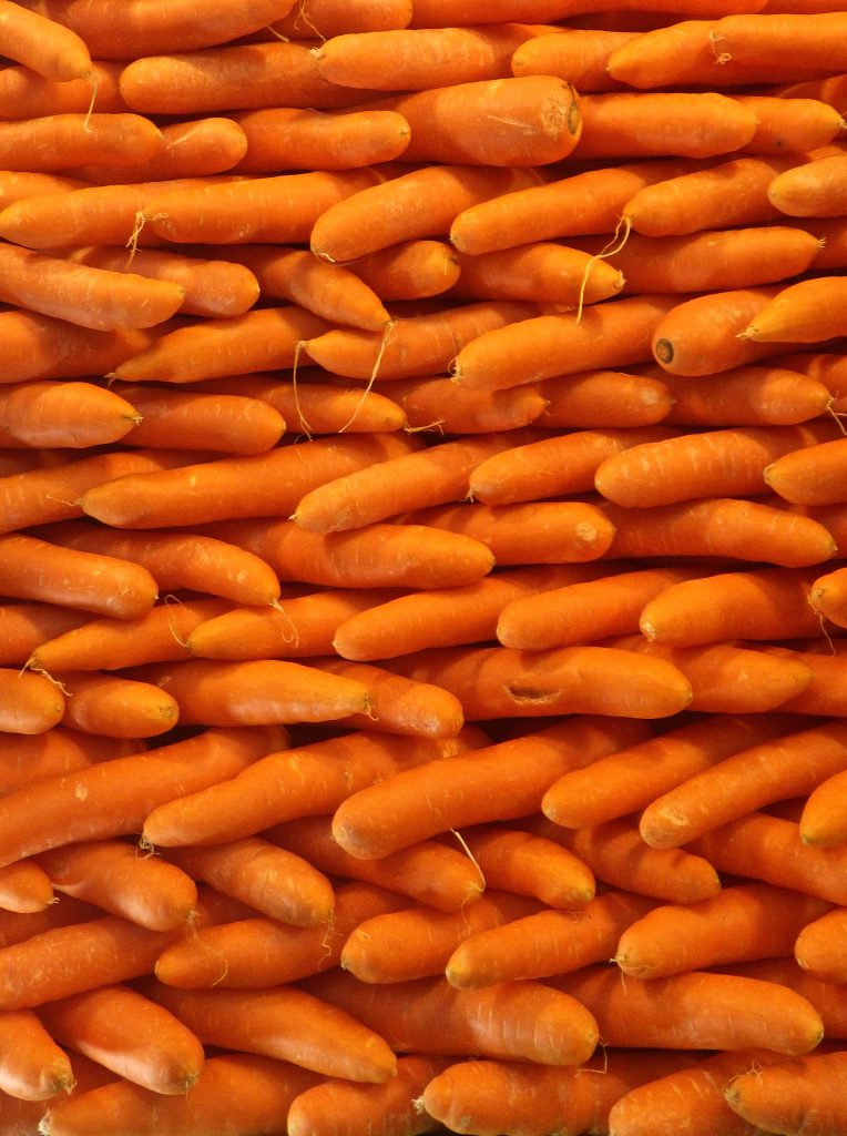 Carrots stacked in a criss-cross pattern at the Central de Abasto, the world's largest wholesale market where Mexico's cultural heritage is also on display. (image © Eva Boynton)
