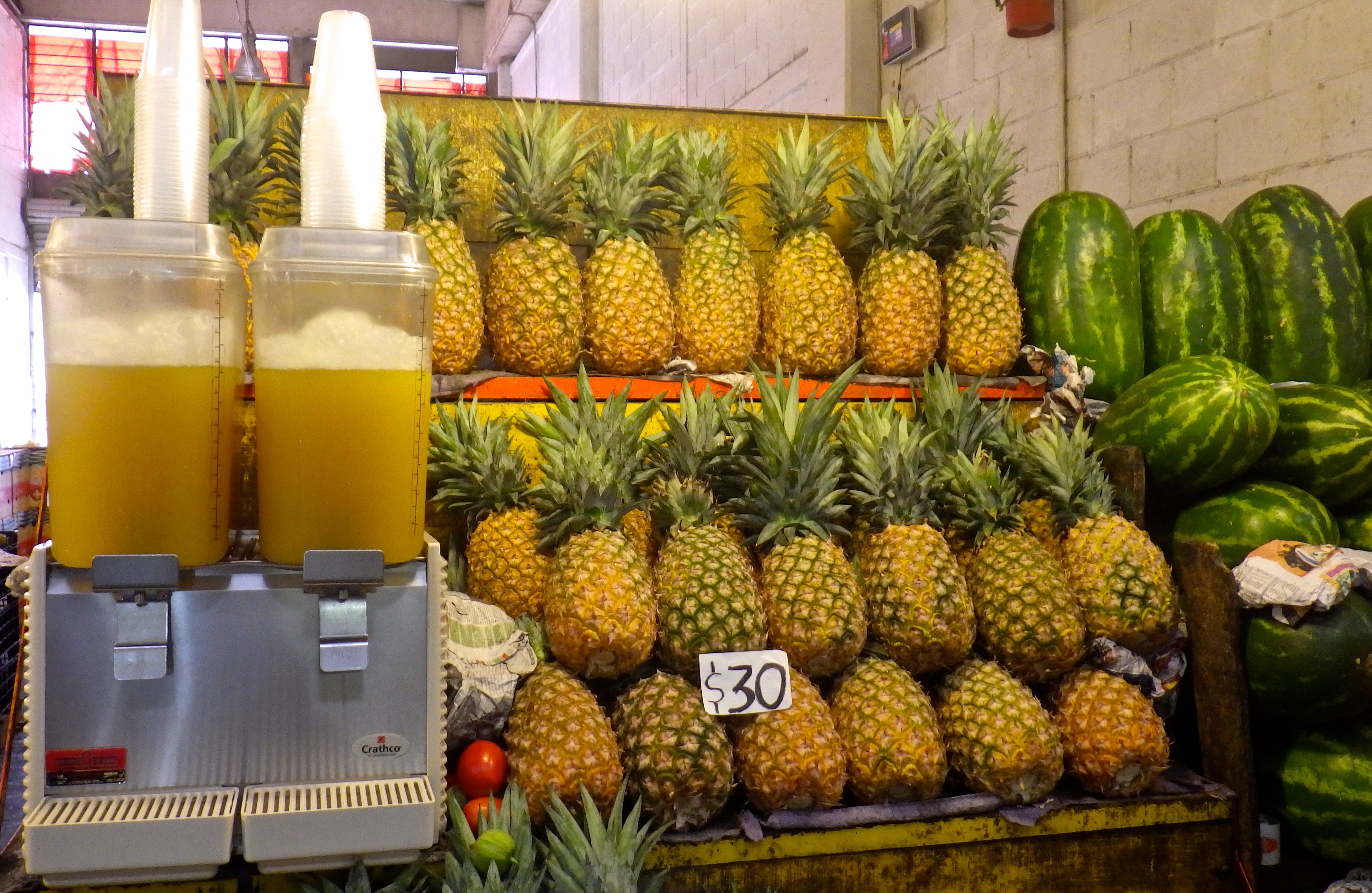 Pineapples stacked with their juice in front at Central de Abasto, the world's largest wholesale market where Mexico's cultural heritage is also on display. (image © Eva Boynton)