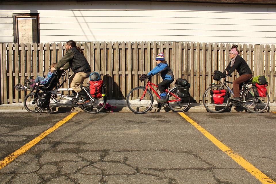 Four family members on bicycles, showing how traveling families share their wanderlust. (image © Conk family) 