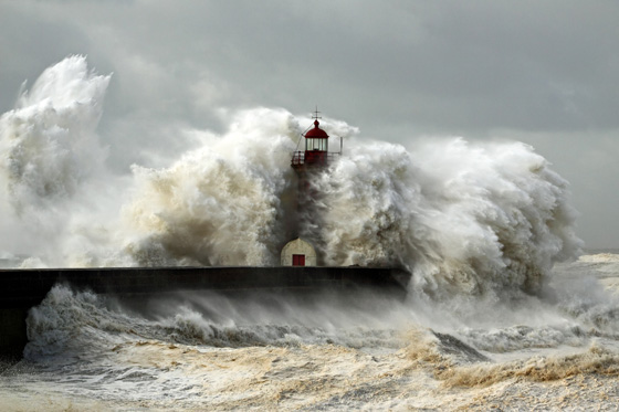 Giant wave over Douro River lighthouse, one of the amazing places on earth to photograph. (Image © Zaharias Pereira de Mata/iStock.)