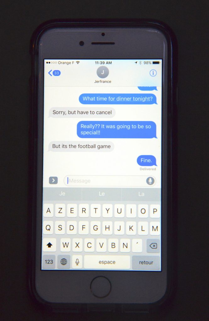 iPhone with text message, showing the language of social media and changing culture. (Image © Meredith Mullins.)
