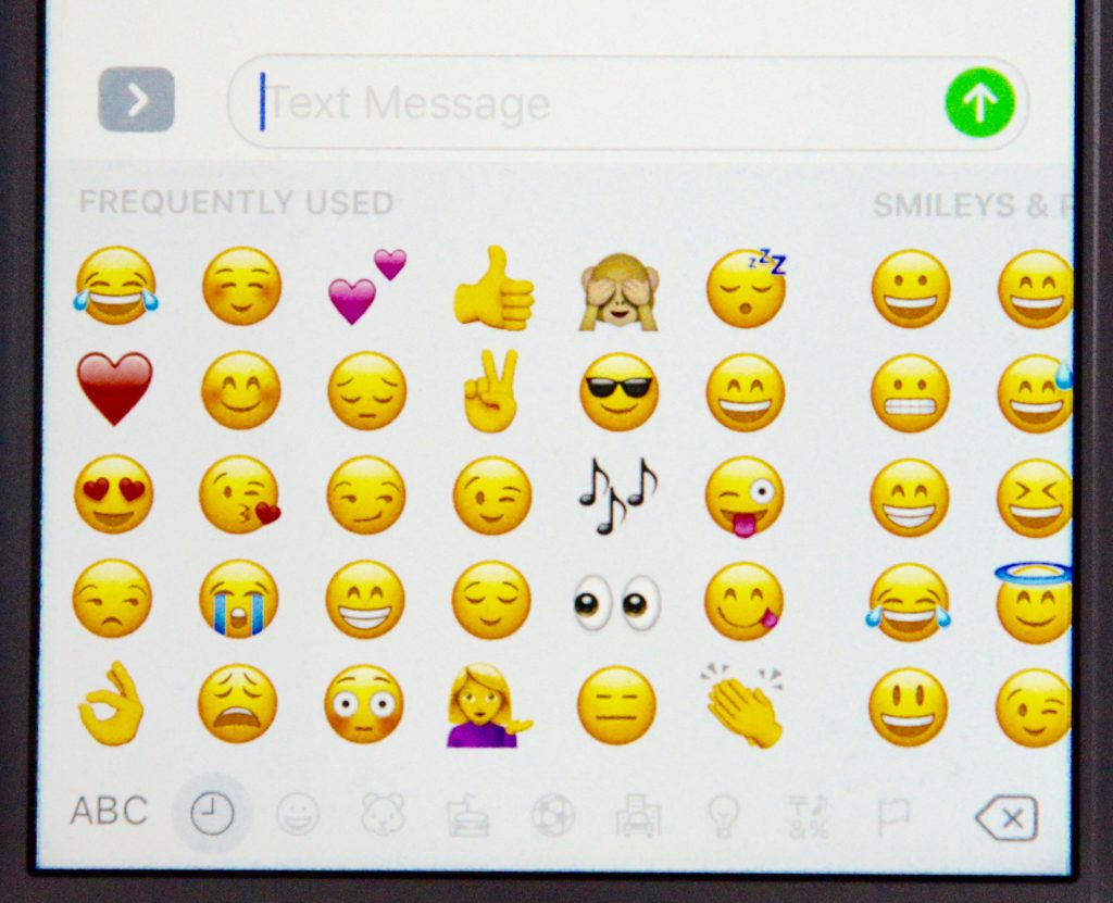 emojis on iPhone, showing the language of social media and changing culture. (Image © Meredith Mullins.)