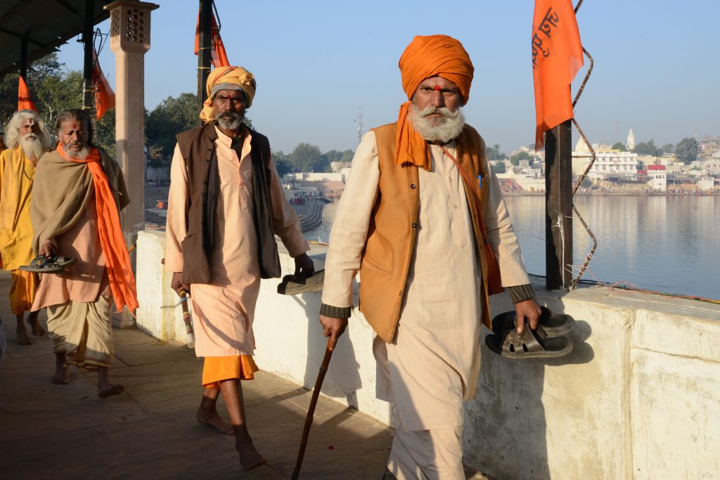 Hindu pilgrims at the Pushkar Lake in Rajasthan, India, during the travel adventures of the Pushkar Camel Fair. (Image © Meredith Mullins.)