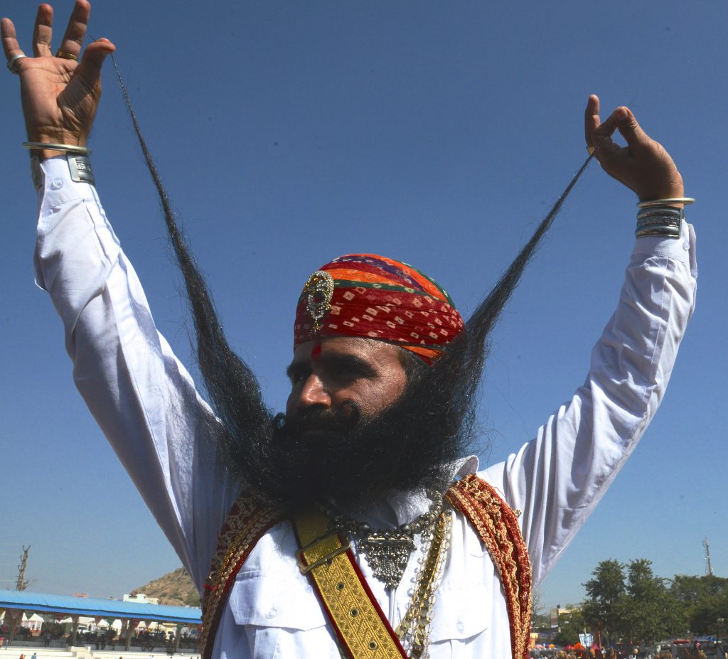 Indian man with long mustache at the Pushkar Camel Fair in Rajasthan, India, a place for travel adventures. (Image © Meredith Mullins.)