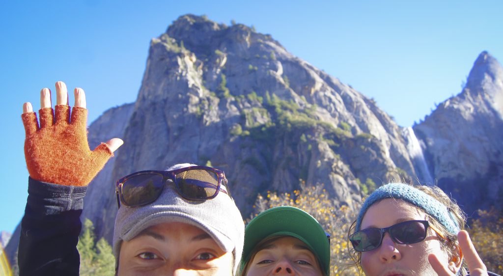 A selfie of three people in front of Yosemite Falls, people trying to experience Yosemite but taking the idea "Open Your Eyes" in the wrong direction. (image © Sam Anaya)