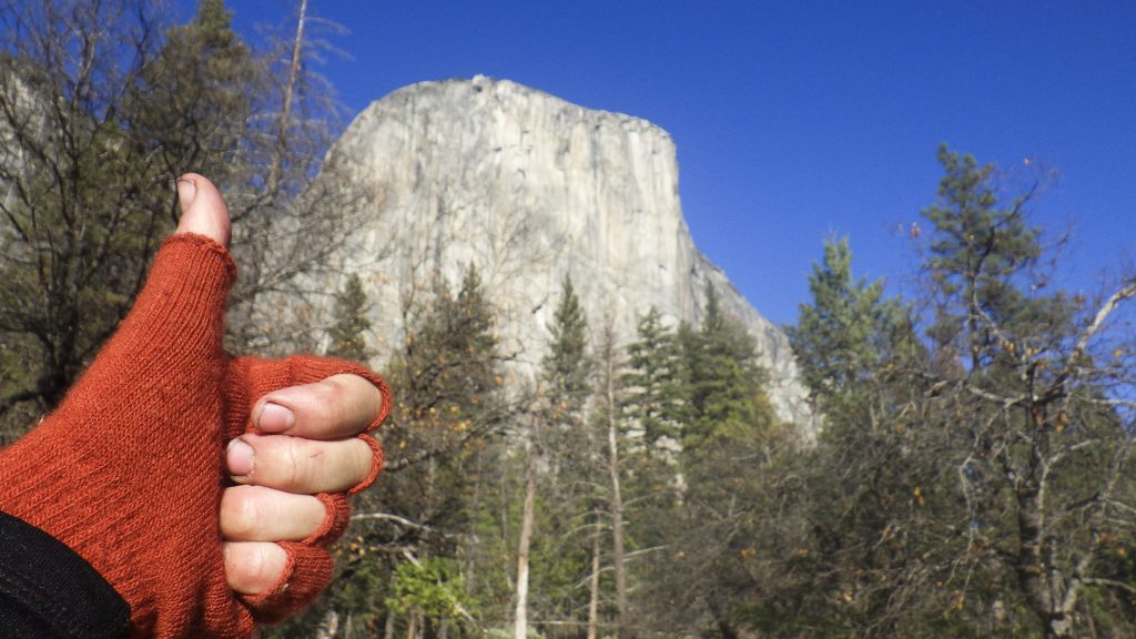 A thumb's up in front of a mountain in Yosemite Valley, a selfie attempts to show how to experience Yosemite. (image © Eva Boynton)