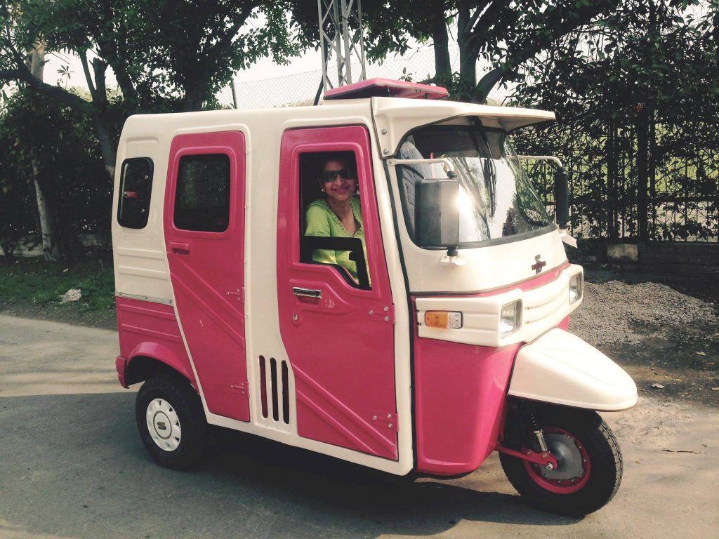 A pink rickshaw, driven by a female driver in Pakistan, illustrating how women advance women's rights and gender equality through pink transportation (image © Sara Naseem).