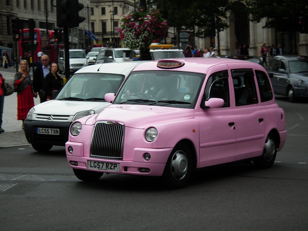A pink taxi in London, showing a pink transportation alternative to help women advance women's rights and gender equality (image © Ken/Flkr).