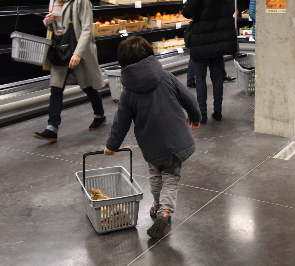 Child shopping at the Paris food co-op La Louve, showing a successful blend of different cultures. (Image © Meredith Mullins.)
