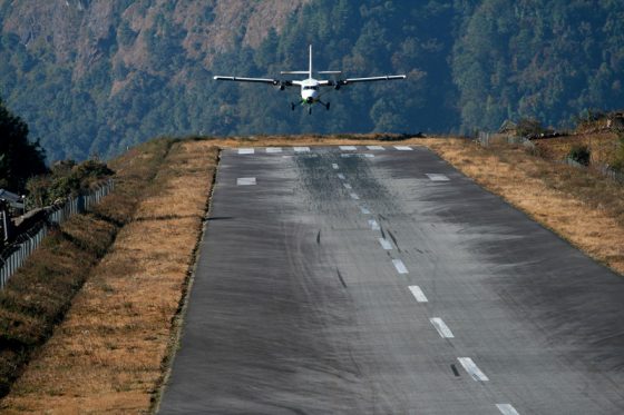 Plane landing at Lukla Airport, offering travel adventures and air travel stories to remember for a lifetime. (Image © je33a/iStock.)