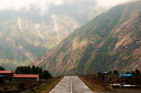 Runway at Lukla airport, offering travel adventures and air travel stories to remember for a lifetime. (Image © Photon Photos.)
