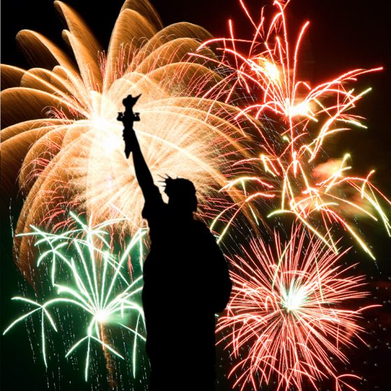 Fireworks behind Statue of Liberty silhouette, a symbol of crossing cultures in celebration of Independence Day. (Image © Stockbyte.)