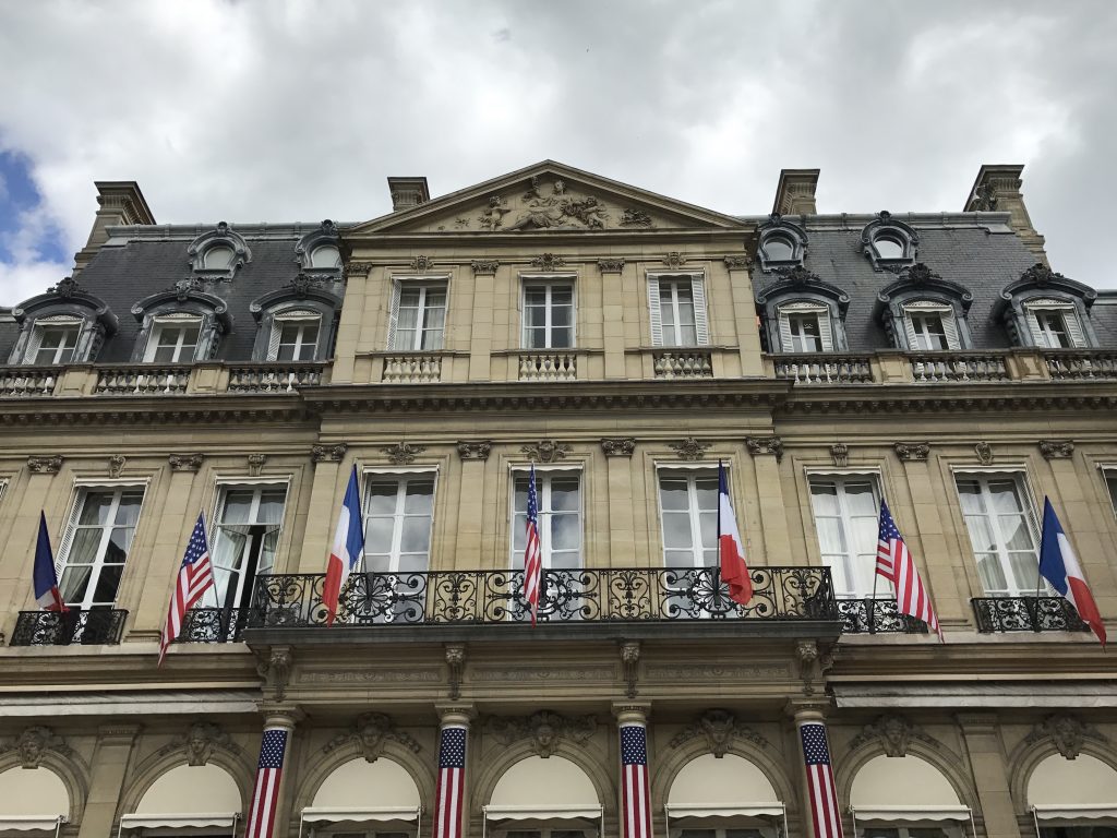 French and U.S. flags at the American Embassy Residence in Paris France, part of crossing cultures in celebration of Independence Day. (Image © Meredith Mullins.)