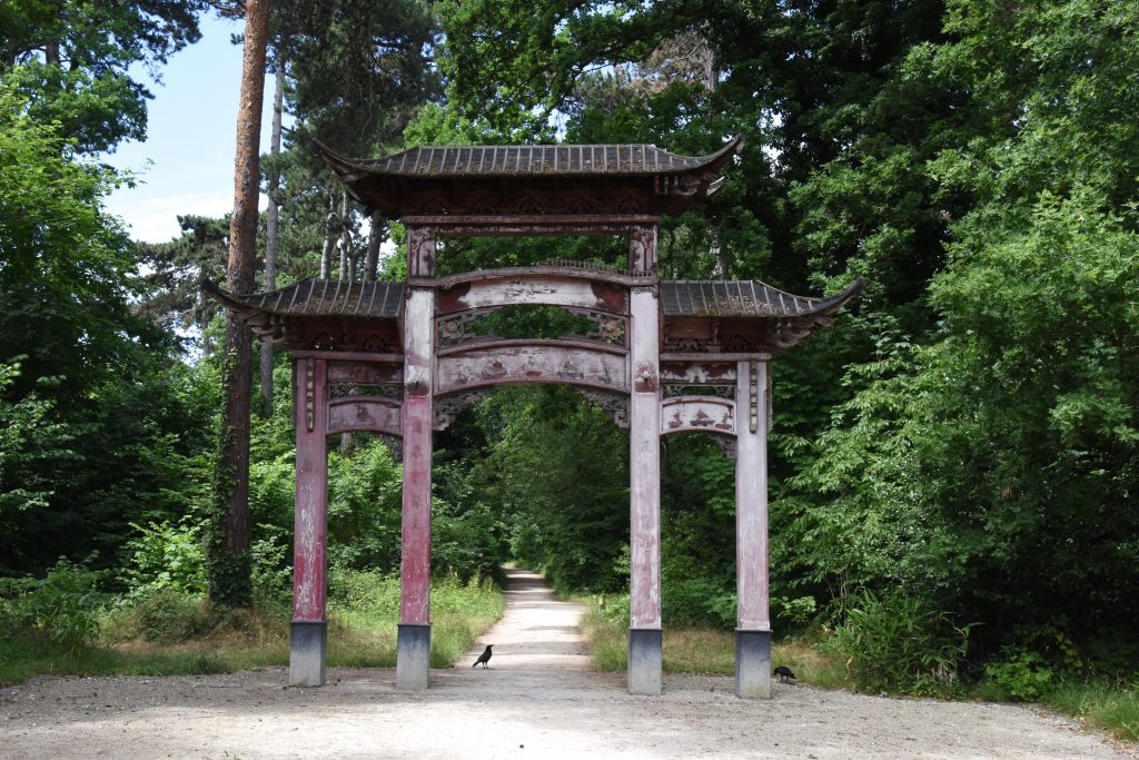 Chinese Torii gate at the Jardin d'Agronomie Tropicale, one of the hidden gardens of Paris where you are traveling the world. (Image © Meredith Mullins.)