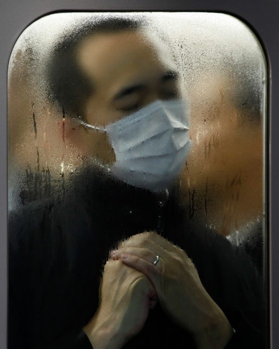 Man with mask on Tokyo subway, part of Michael Wolf's Tokyo Compression series, crossing cultures to show life in cities. (Image © Michael Wolf.)