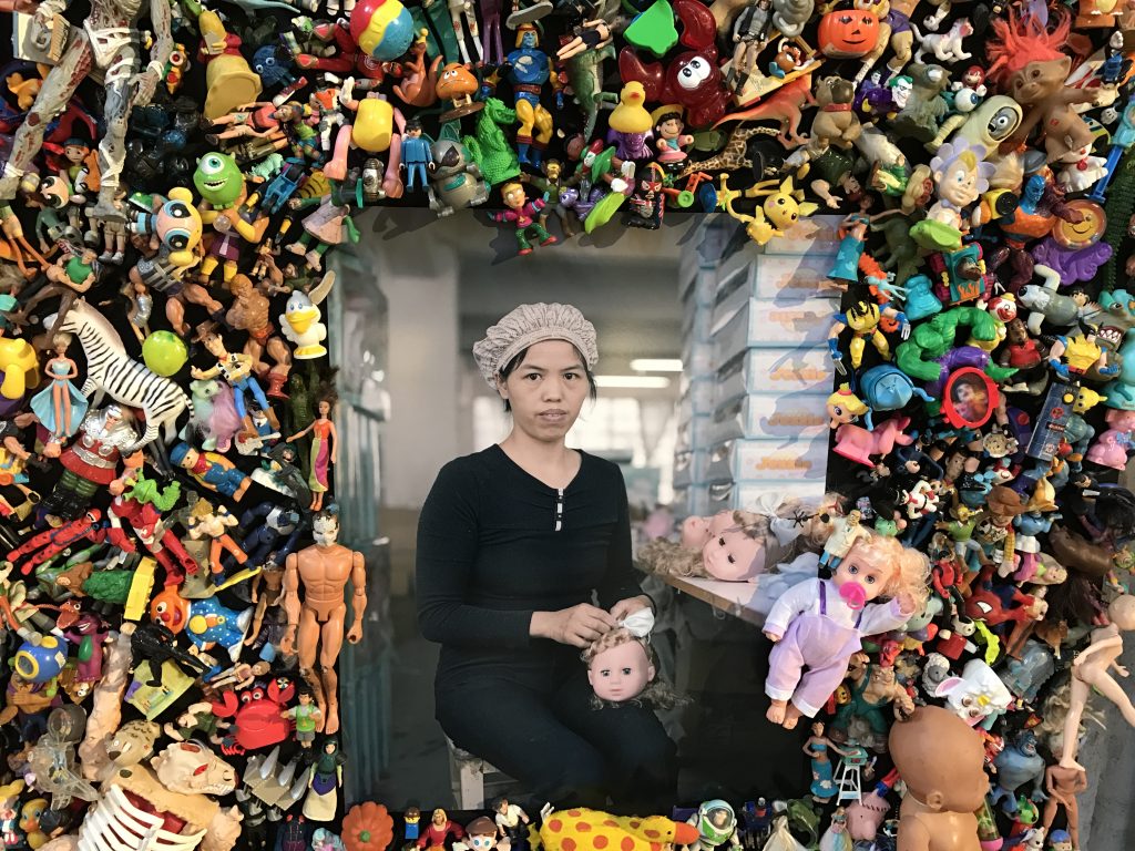 Female Chinese worker as part of Michael Wolf's The Real Toy Story installation at the Rencontres d'Arles, crossing cultures to show life in cities. (Image © Meredith Mullins/Installation © Michael Wolf.)