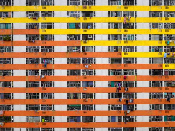 orange and yellow apartment building in Hong Kong from Michael Wolf's Architecture of Density series, crossing cultures to show life in cities. (Image © Michael Wolf.)