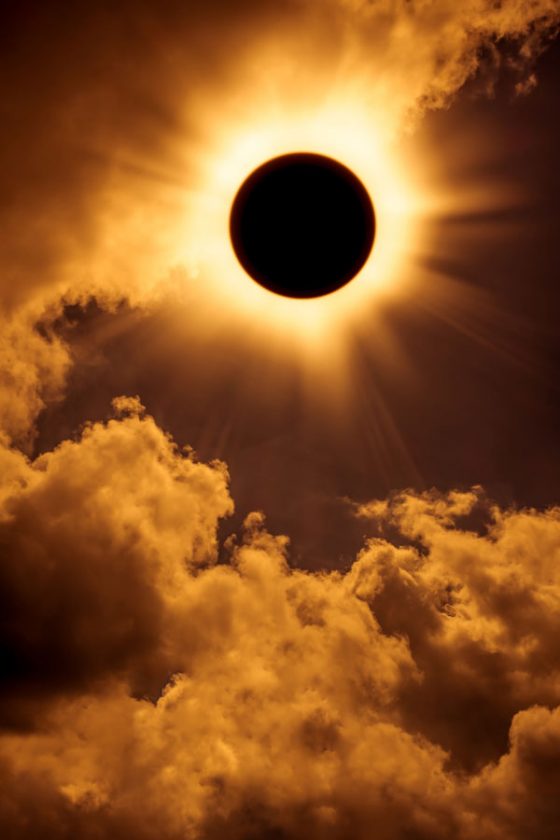 Total solar eclipse with clouds, travel inspiration for the 2017 total solar eclipse. (Image © kdshutterman.)