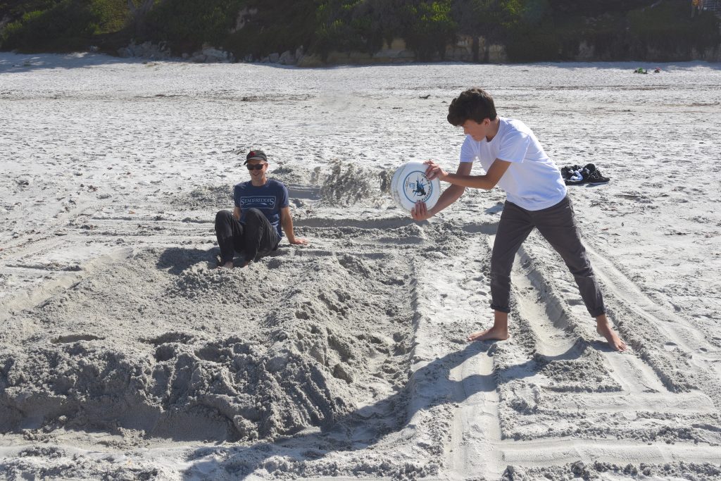 Two people digging sand maze for their sand sculpture, discovering the art of sand sculptures at the Great Carmel Sand Castle Contest. (Image © Meredith Mullins.)