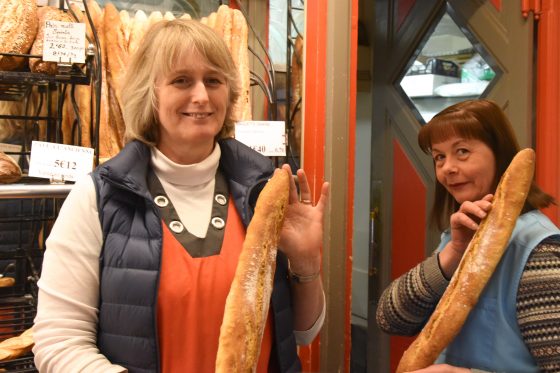 A French bakery (boulangerie) with two women selling baguettes, illustrating baguettiquette, a form of French wordplay about the etiquette of eating baguettes. (Image © Meredith Mullins.)
