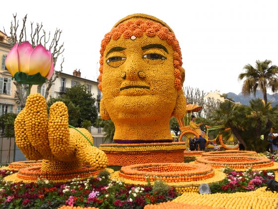 A Buddha made of lemons and oranges at the Menton Lemon Festival, travel inspiration for unusual events. (Image © Meredith Mullins.)