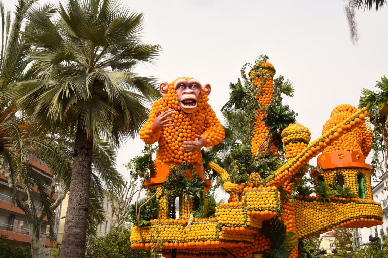 A monkey sculpture made of lemons and oranges at the Menton Lemon Festival, travel inspiration for unusual events. (Image © Meredith Mullins.)