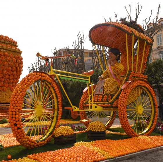 A rickshaw made of lemons and oranges at the Menton Lemon Festival, travel inspiration for unusual events. (Image © Meredith Mullins.)