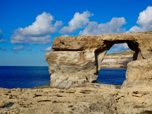 The Azure Window graces the rugged coast of Gozo, Malta, a place that Edward visited with a traveler's wanderlust and one that inspired his wordplay and watercolor paintings. (Image by Joyce McGreevy)