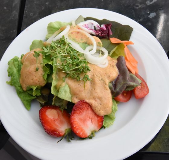 Salad with avocado vinaigrette dressing, a healthy recipe from Chef Hubert Hohler, showing a cultural encounter with healthy eating. (Image © Meredith Mullins.)