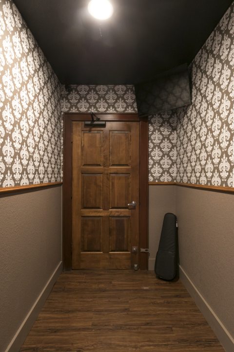 Narrow room with violin case in the Exodus Escape Room, one of the escape rooms around the world that offers cultural encounters and life lessons. (Image © Richard Green/Exodus Escape Room.)