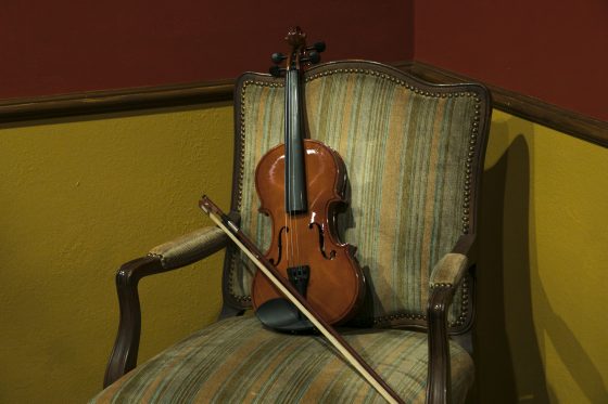 Sherlock Holmes violin in the Exodus Escape Room in Monterey, California, one of the escape rooms around the world that offers cultural encounters and life lessons. (Image © Richard Green/Exodus Escape Room.)