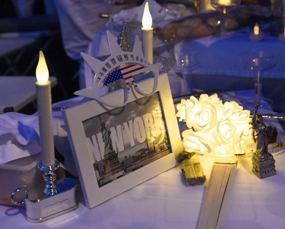 A table setting in tribute to New York at the Paris Dîner en Blanc, showing cultural traditions of the Dinner in White. (Image © Meredith Mullins.)