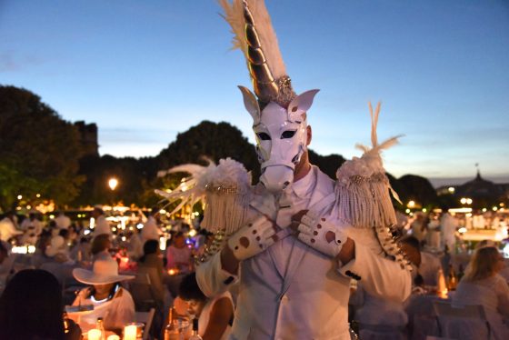 White unicorn at the Paris Dîner en Blanc, enjoying the cultural traditions of the Dinner in White. (Image © Meredith Mullins.)