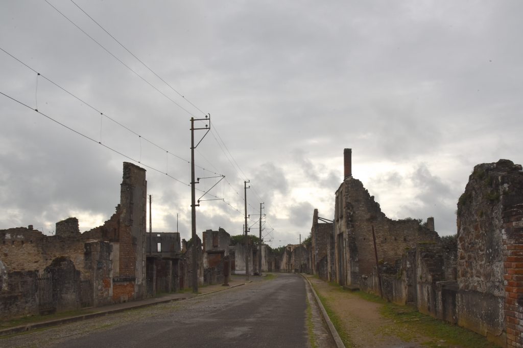 Main street of Oradour-sur-Glane, with ruined buildings, part of the cultural history of WW II in France. (Image © Meredith Mullins.)