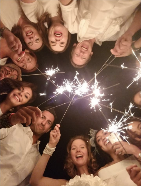 Circle of Paris Dîner en Blanc guests with sparklers, enjoying the cultural traditions of the Dinner in White. (Image © Fatima Negaran.)