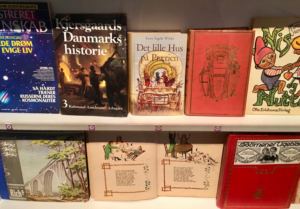 Vintage books on display in Aarhus, Denmark symbolize reading while traveling to distant places and times, through a wanderlust for words. (Image © Joyce McGreevy)