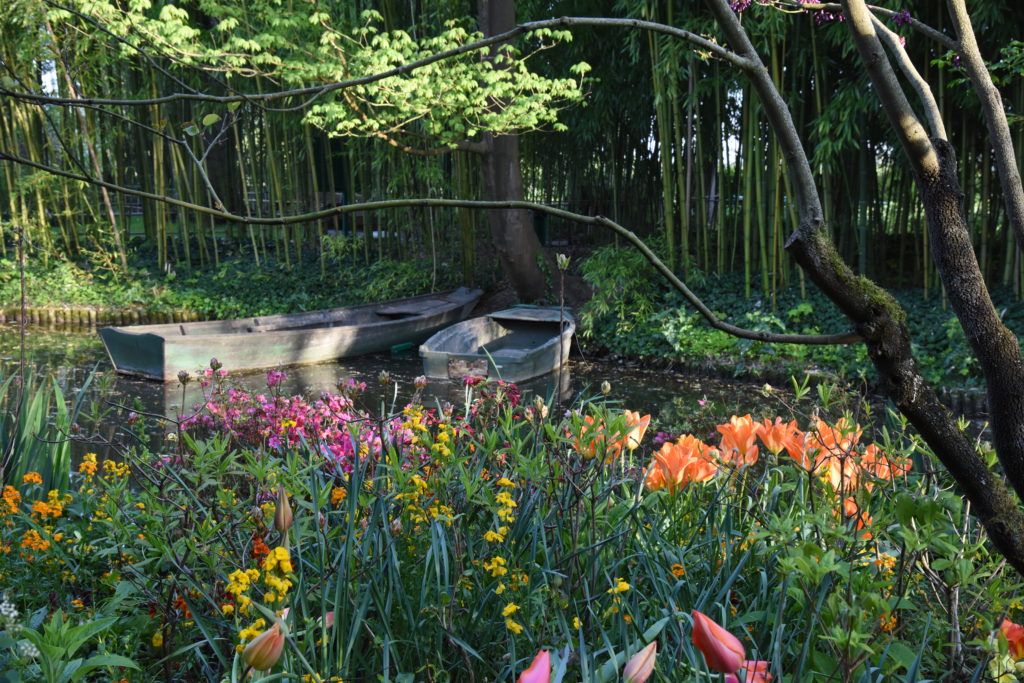 Boats in the waterlily pond, travel inspiration from Monet's Giverny gardens in France. (Image © Meredith Mullins.)